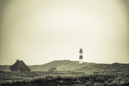 Lighthouse List-ost, with house in dune landscape, List, island Sylt, Germany
