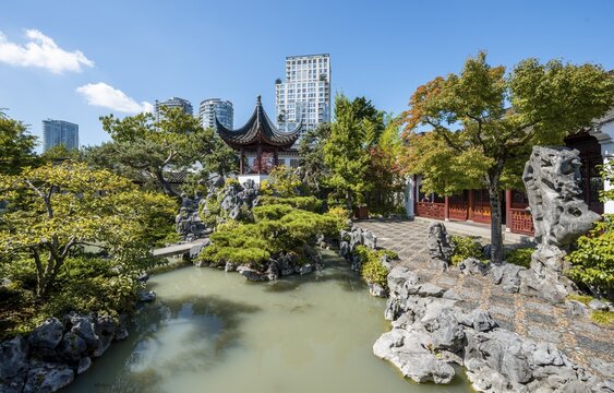 Traditional Chinese Pagoda in Dr. Sun Yat-Sen Classical Chinese Garden, in front of skyscrapers, Vancouver, British Columbia, Canada