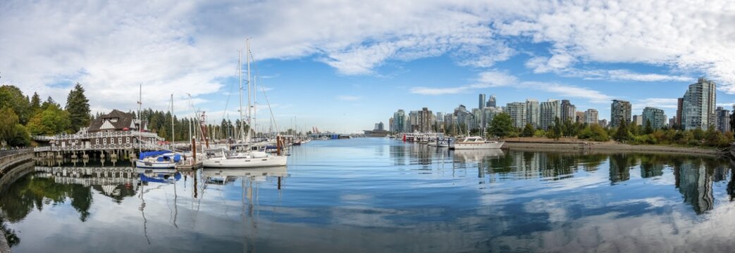 Skyscrapers and sailboats in the marina, skyline of Vancouver reflected in the sea, Coal Harbour, Downton Vancouver, British Columbia, Canada