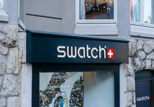 Cortina D Ampezzo, Italy - March 07, 2026: Swatch store exterior featuring logo and window display with colorful watch designs in a city setting, showcasing Swiss brand identity