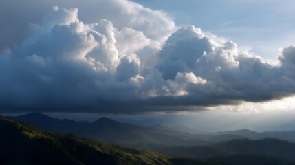 Fototapeta premium Majestic mountain ranges under a dramatic sky with sunlight breaking through illuminating the landscape
