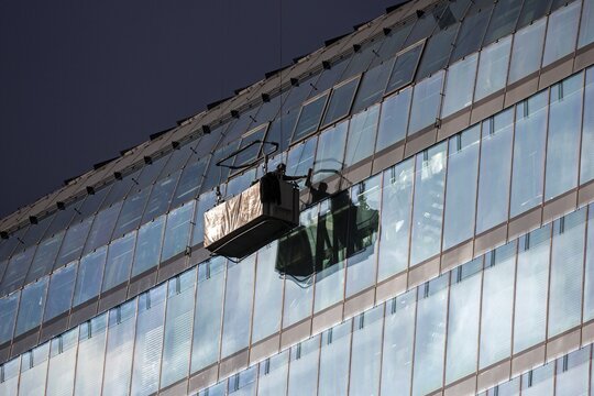 Window cleaner at an office building, Medienhafen, D&uuml;sseldorf, Ruhr area, North Rhine-Westphalia, Germany