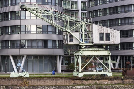 Old harbour crane in front of Five Boats office building, Inner Harbour, Duisburg, Ruhr Area, North Rhine-Westphalia, Germany