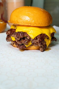 Classic tripple smash cheeseburger with molten cheddar cheese on brioche bun