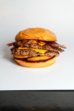 Double smash burger topped with crispy fried onions smoky bacon and melted cheese on brioche bun