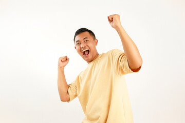 Fototapeta premium Portrait of Asian Man with Excited Expression and Victory Gesture Isolated on White Background