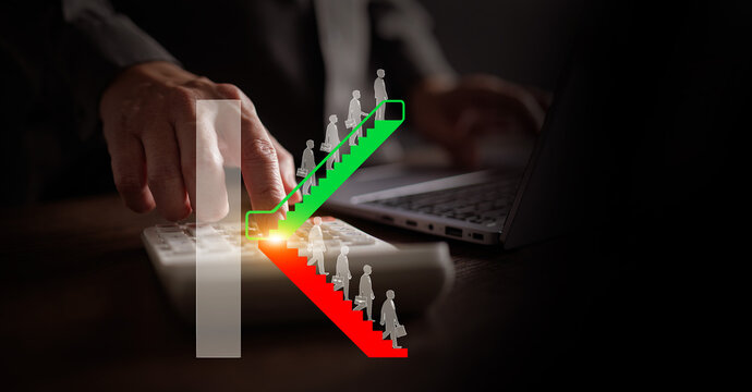 K-shaped economic recovery concept. Businessman uses a calculator with K shape escalator graph of divergence between high-growth and low-growth sectors or industries. Uneven, split economy rebound