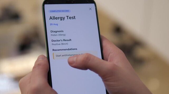 Close up of man holding smartphone with digital allergy test results on screen. Online medical report shows pollen diagnosis and treatment advice. Modern telemedicine, healthcare app and remote