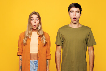 Young shocked surprised amazed couple two friends family man woman wear casual clothes looking...
