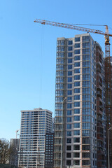 Fototapeta premium construction site with crane and building, blue sky background