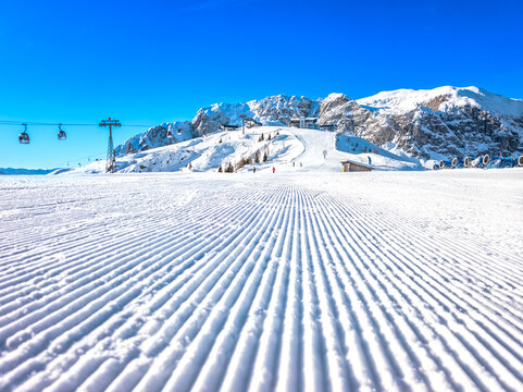 Nassfeld Ski Resort Winter Scene with Skiers, Corduroy Slopes and Sun Rays, Austria