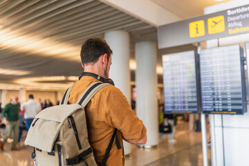 Traveler checking flight departure information at airport © Martí Rosselló