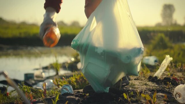 An environmental activist diligently collects and sorts plastic trash and garbage outdoors during the evening, promoting nature's cleanup and sustainable use of recycled materials