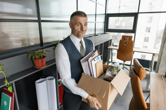 Business man packing stuff empty office. Last day at work. Upset office worker fired. Fired and unemployment with business man. Job loss. Fired jobless employee. Unemployment crisis of man dismissed