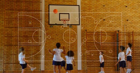 Playing kids in white Ts navy shorts reaching for basketball above hoop in school-gym, X or O overla