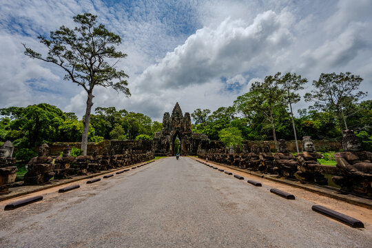 Stone guardian statues lining the south gate of Angkor Thom in Cambodia