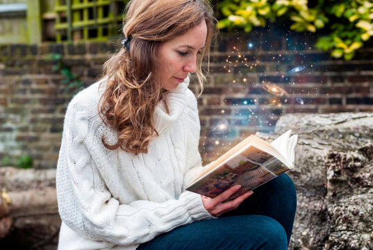 Visionary woman reading book revealing cosmic imagination