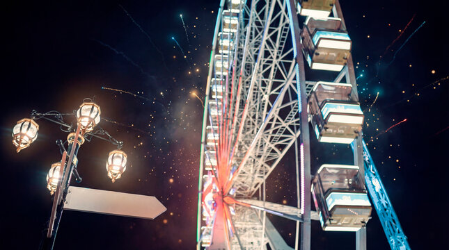 Vibrant ferris wheel glowing during festive night celebration