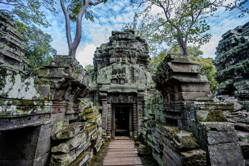 Fototapeta premium Ancient stone entrance of Ta Prohm temple in Angkor