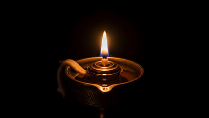 Fototapeta premium Serene Traditional Oil Lamp with Flickering Flame Soft Warm Golden Lighting Peaceful Ambiance Cinematic Photography