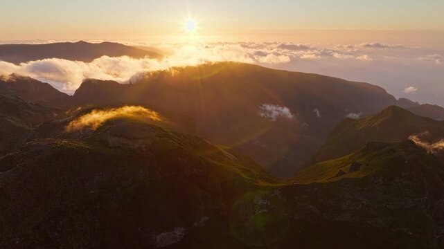 Aerial view of flying at Pico Ruivo of mountains with clouds on sunset. Madeira island, Portugal