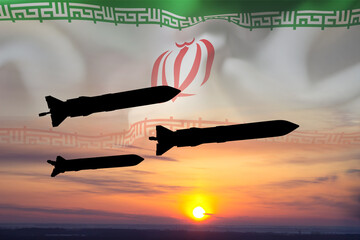 Obraz premium Silhouette of missiles with Iran flag against the sunset. Bomb, chemical weapons, missile defense, a system of salvo fire