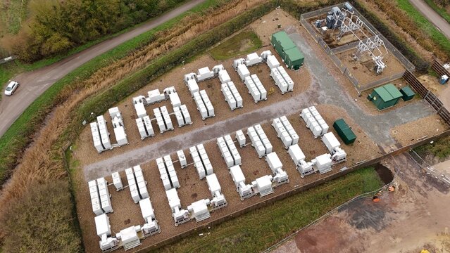 Aerial drone view of a large-scale battery energy storage system (BESS) in Burwell, UK, supporting grid resilience and renewable power supply.