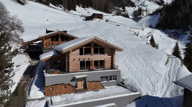 Aerial view of luxury wooden chalet in snowy mountain village