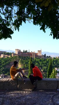 Travelers relaxing with Alhambra palace view in Granada