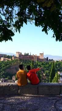 Couple pointing at historic Alhambra landmark
