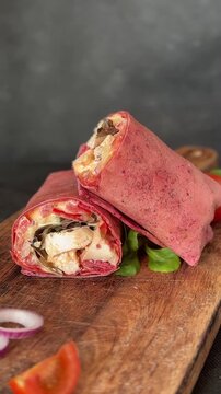 Shawarma wrap chicken and vegetables pink lavash doner kebab tasty snack fresh gourmet food background on the table rustic food top view copy space dark background marketing concept photo