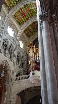 Religious architecture interior with colorful murals and organ musical instrument