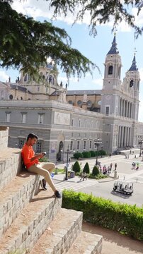 Traveler relaxing with Almudena Cathedral view Madrid Spain