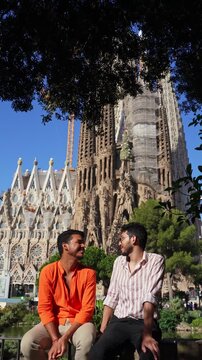 Gay couple kissing in front of Sagrada Familia Barcelona