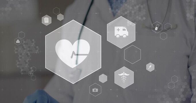Senior male doctor tapping tablet, engaging hex UI highlighting heart icon for medical monitoring