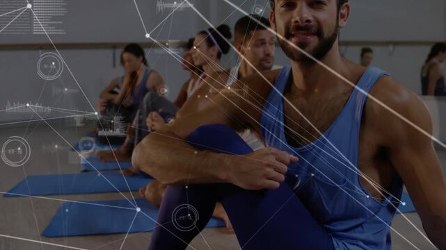Camera pushing in, man adjusting knee, centering in fitness class, HUD graphics weaving across man