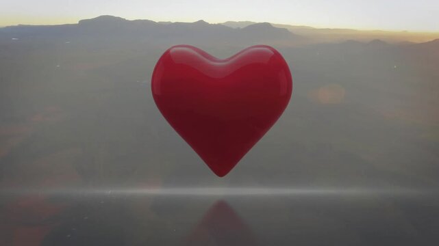 Dawn light hitting glossy red 3D heart, elongating, enlarging, revealing mountain ridge within