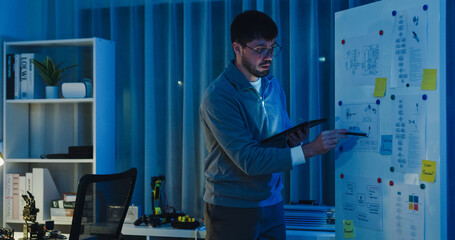 Team adult male engineer develop present AI robotics hand project at tech workspace night....