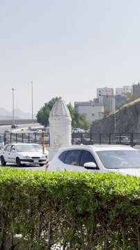 Visual of the white Haram boundary pillar near Masjid Aisha (Taneem) in Makkah. This site serves as a Miqat point where pilgrims enter Ihram for Umrah, marking the sacred limits of the holy city.