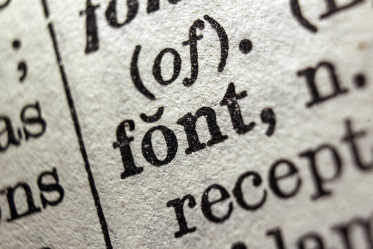 Word font printed on a dictionary page, macro closeup