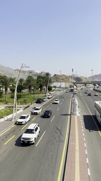 Visual of the white Haram boundary pillar near Masjid Aisha (Taneem) in Makkah. This site serves as a Miqat point where pilgrims enter Ihram for Umrah, marking the sacred limits of the holy city.