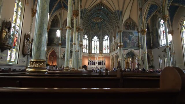 Interior view of a grand cathedral with ornate architecture and stained glass windows