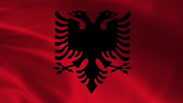 Albanian flag with a black double-headed eagle emblem waving fabric texture representing national pride and patriotism for Albania