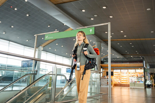 Woman exploring airport on a solo travel adventure