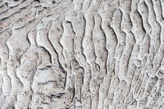 Textured travertine stone surface with natural patterns