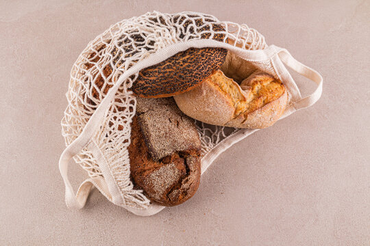 Assortment of breads in a reusable mesh bag