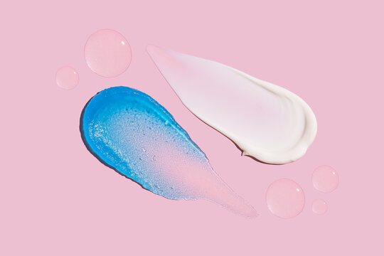 Cosmetic swatches on a pink background