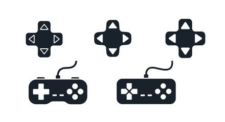 Black game controllers and directional pads in a dark silhouette © mst