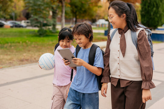 Asian children enjoying their walk outside together