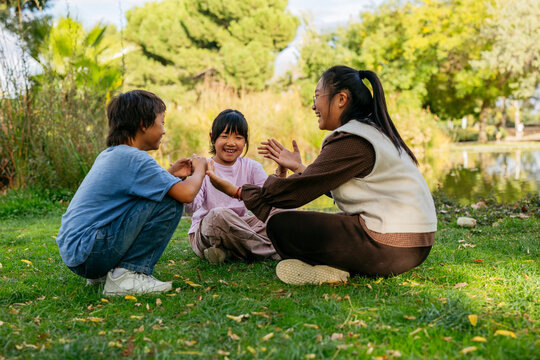 Asian children playing together in a park setting